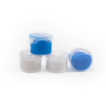 Three small containers with blue and white powders on a white background