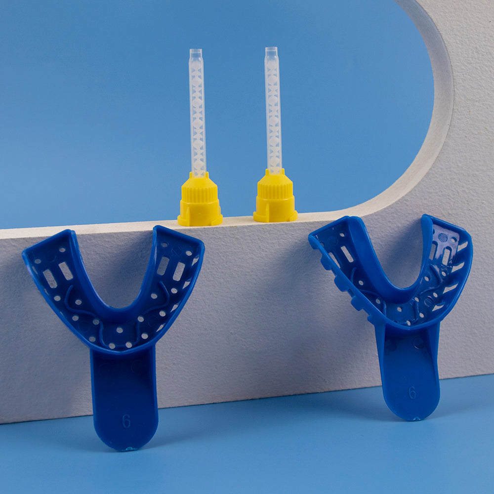 Two blue mouthguards on a blue background with yellow dental tools in the background.