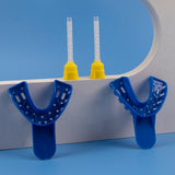 Two blue mouthguards on a blue background with yellow dental tools in the background.