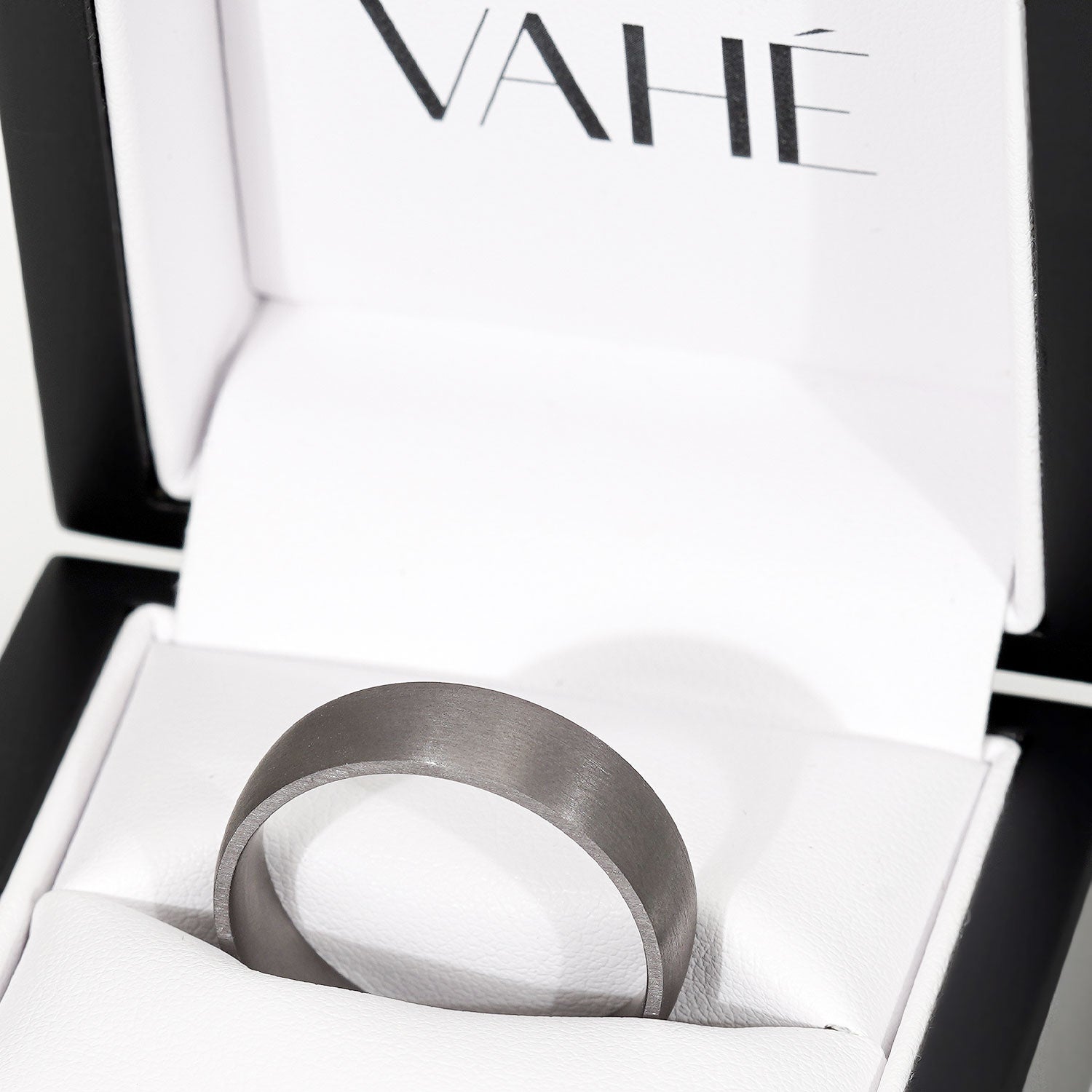 Dark ring in a box with 'VAHE' branding