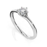A classic solitaire engagement ring featuring a round brilliant-cut diamond set in a polished silver-colored metal band, shown on a clean white background with a soft reflection.