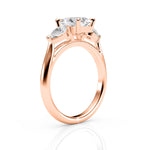 Rose gold ring with three clear gemstones on a white background