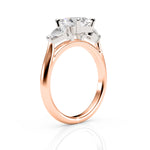Rose gold ring with a large diamond and smaller diamonds on a white background