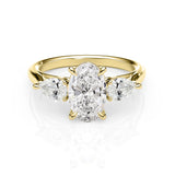 Gold ring with a central diamond and two smaller diamonds on a white background