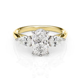 Gold and silver ring with a central diamond and three smaller diamonds on a white background