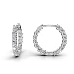 ILAYDA claw set diamond huggie earrings in white gold, 0.90ct total weight, angled side view