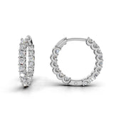 ILAYDA claw set diamond huggie earrings in white gold, 0.90ct total weight, angled side view