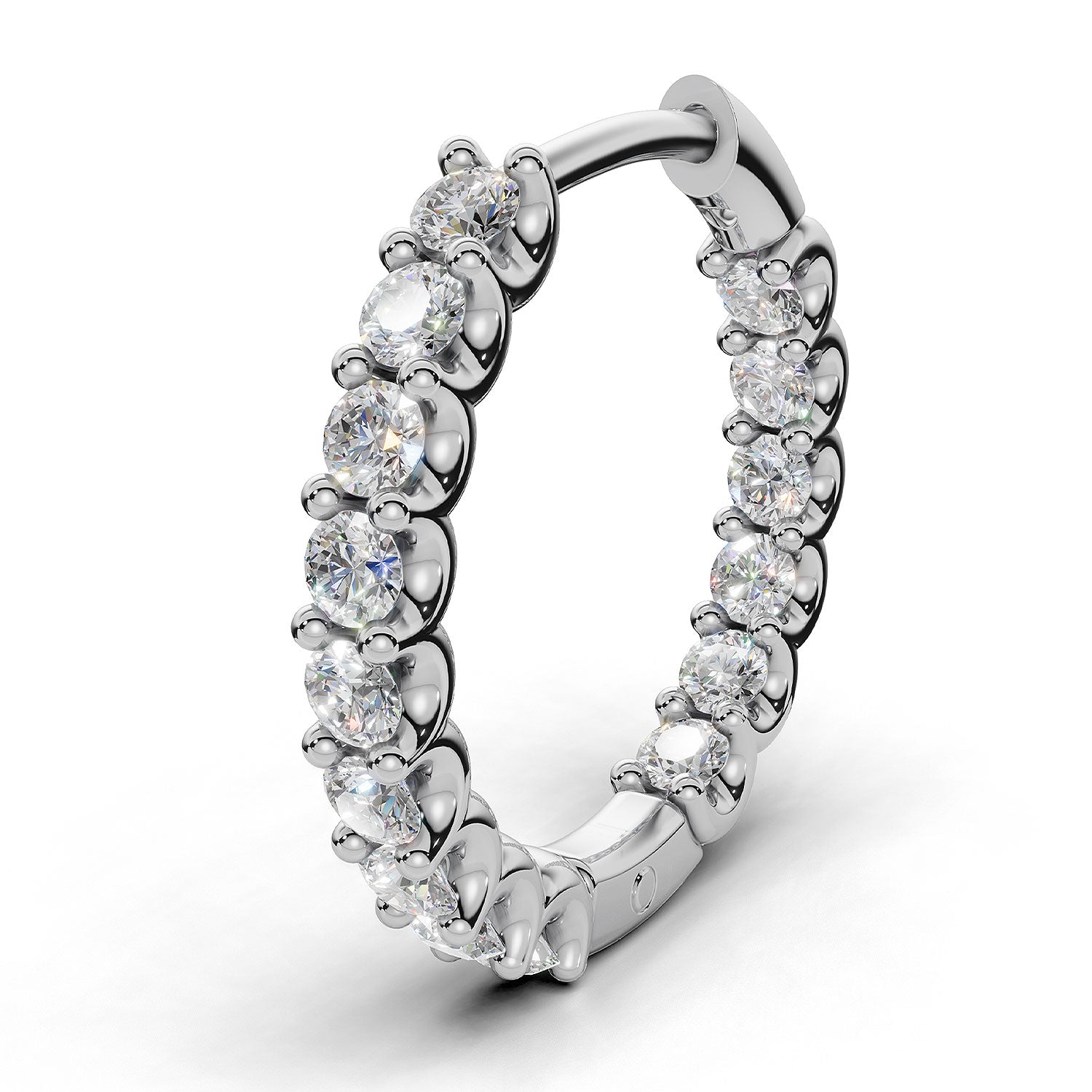 ILAYDA claw set diamond huggie earrings in white gold, 0.90ct total weight, close-up of the scalloped claw setting