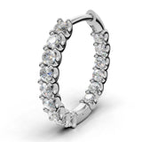 ILAYDA claw set diamond huggie earrings in white gold, 0.90ct total weight, close-up of the scalloped claw setting
