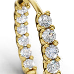 ILAYDA diamond huggie earrings in yellow gold, macro detail of the claw-set diamonds and U-scallops