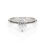 Diamond ring with pear-shaped gemstone on a white background