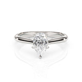 Diamond ring with pear-shaped gemstone on a white background