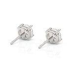 Pair of silver stud earrings on a white background