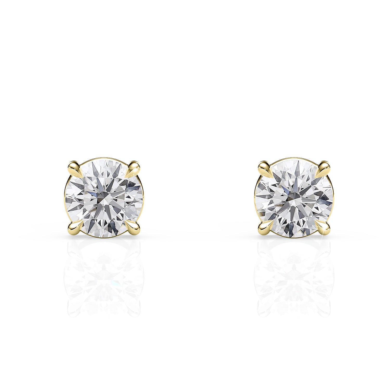 Pair of gold stud earrings with clear gemstones on a white background