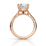 Rose gold diamond ring with a heart-shaped clear center stone and small accent diamonds along the band, shown on a white background with a soft reflection.