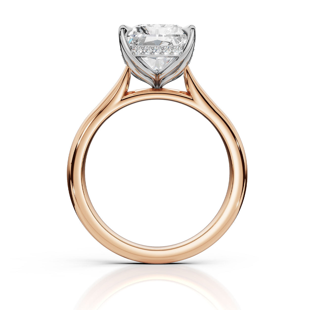 A rose gold diamond ring with a large round-cut center stone and smaller accent stones in a silver-colored setting, shown on a clean white background with a soft reflection below.