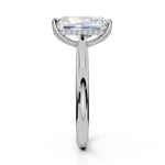 An emerald-cut diamond engagement ring in a polished white gold or platinum setting, shown from a front-facing perspective on a clean white background.