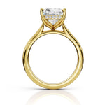 A yellow gold solitaire engagement ring featuring a heart-shaped clear gemstone in a prong setting with a row of small accent diamonds along the band, shown on a white background with a soft reflection.