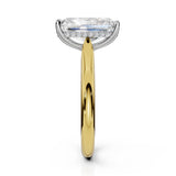 An engagement ring featuring a large rectangular emerald-cut diamond set in a silver-colored halo with a yellow gold band, shown on a clean white background.