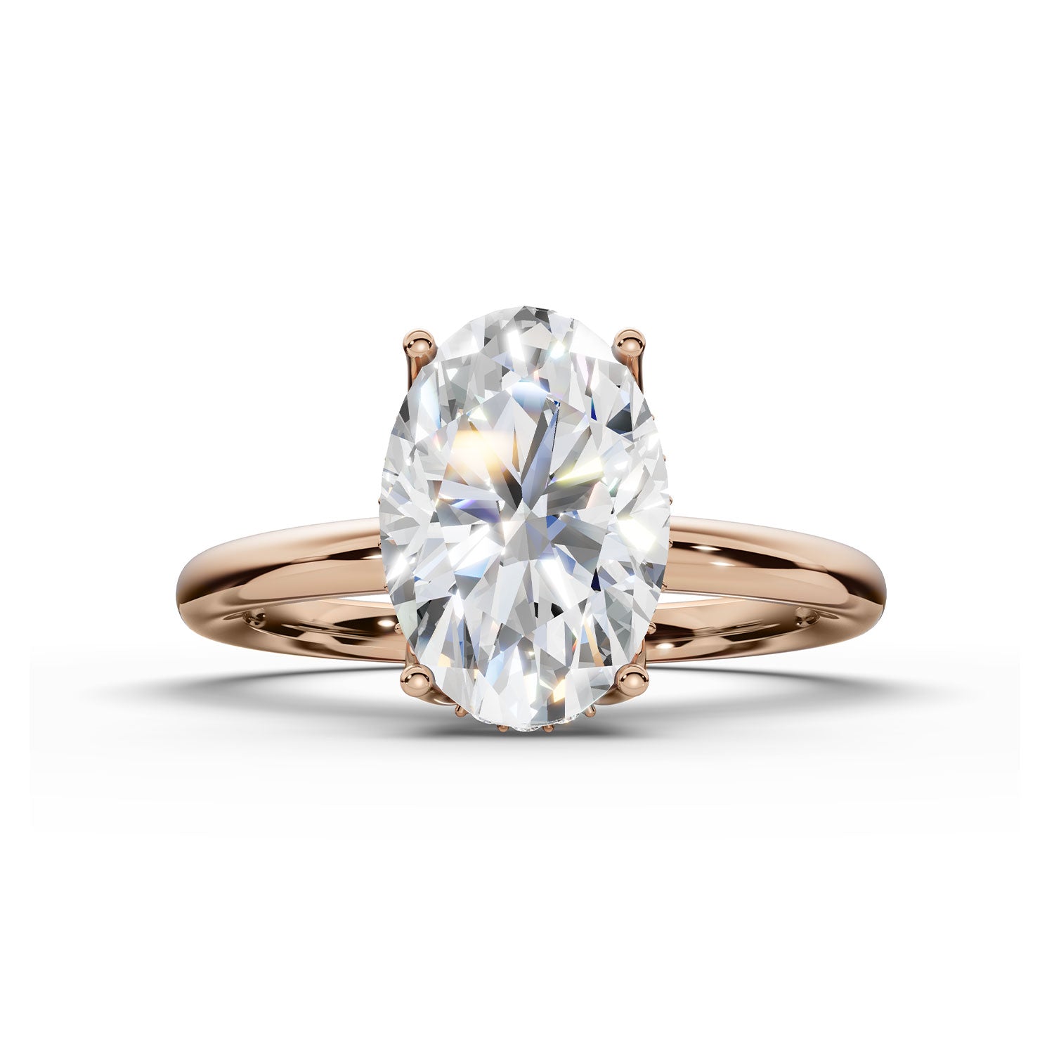 An oval-cut diamond engagement ring in a rose gold setting, shown on a clean white background with a soft shadow.