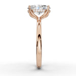 A rose gold engagement ring featuring a large oval-cut center stone and a halo of small round stones, shown in a clean front-facing studio shot on a white background.