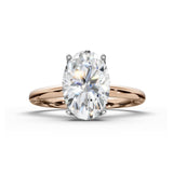 An oval-cut diamond engagement ring with an oval-cut center stone and a polished rose gold band, shown on a clean white background.