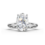 An oval-cut diamond engagement ring with a polished silver-colored band, shown on a clean white background with a soft shadow.