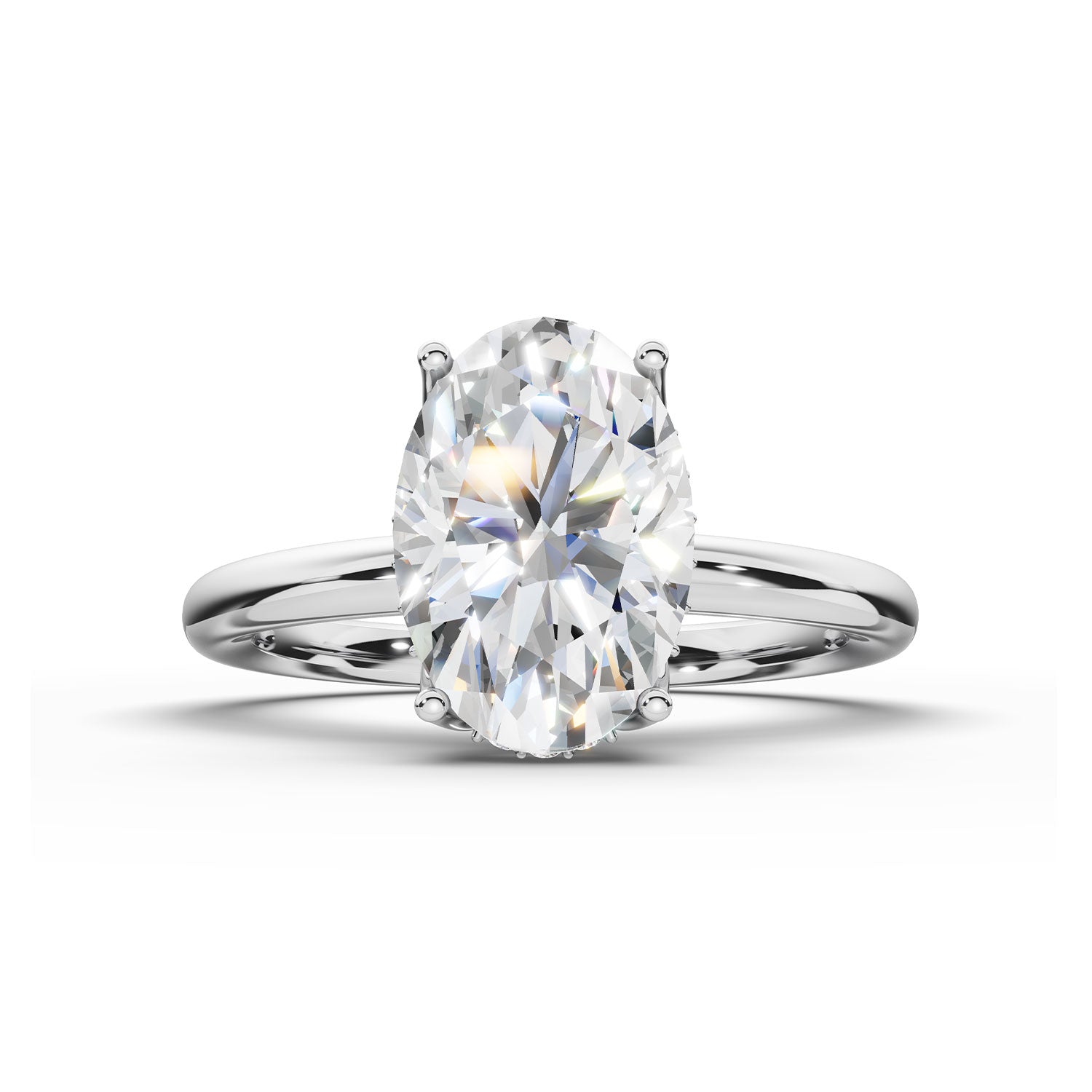 An oval-cut diamond engagement ring with a polished silver-colored band, shown on a clean white background with a soft shadow.