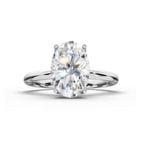 An oval-cut diamond engagement ring with a polished silver-colored band, shown on a clean white background with a soft shadow.