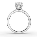 A classic solitaire engagement ring featuring a round brilliant-cut diamond set in a four-prong white gold or platinum band, shown on a clean white background.