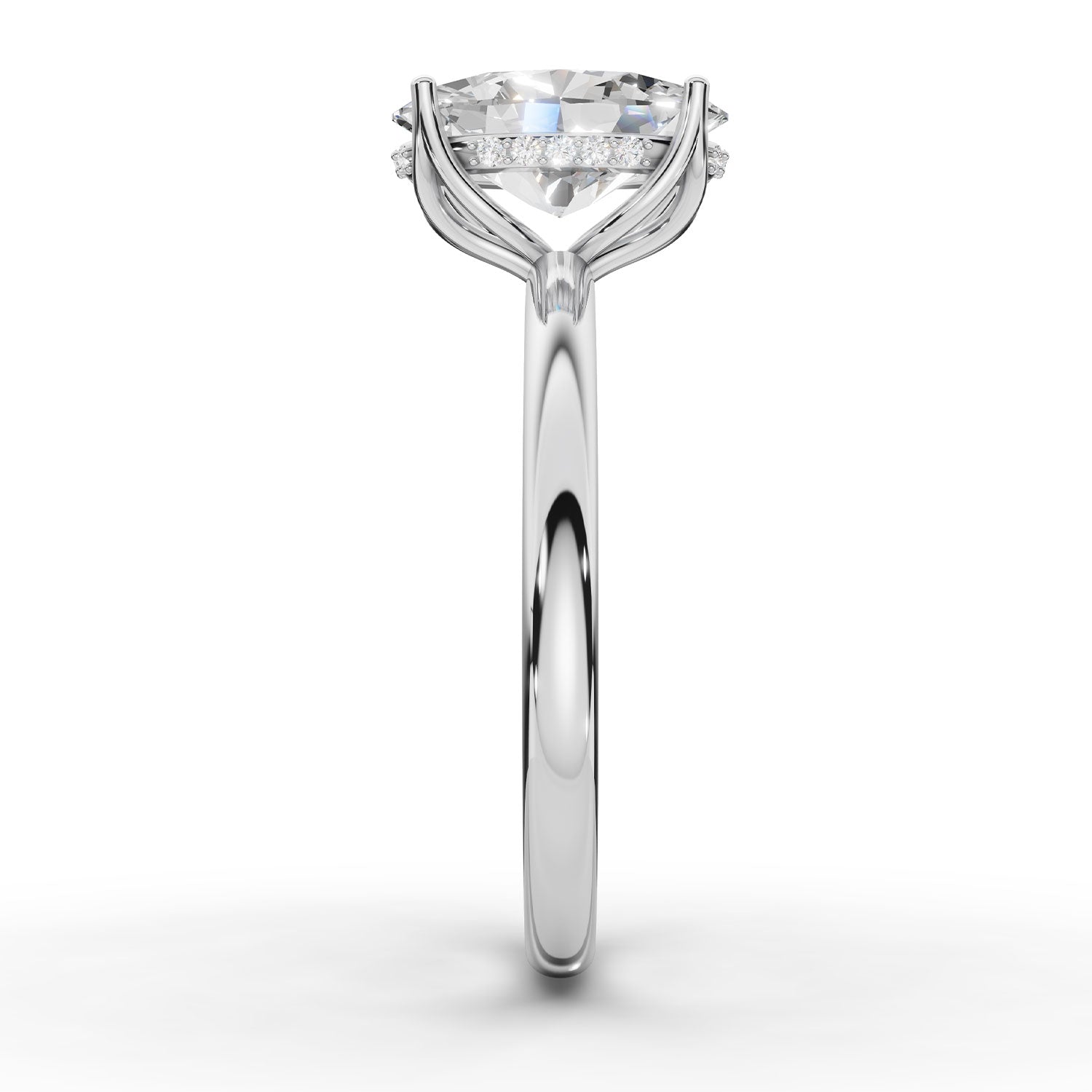A classic solitaire engagement ring featuring a round brilliant-cut diamond set in a polished white gold or platinum band with a halo of smaller diamonds, shown on a clean white background.