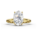 An oval-cut diamond engagement ring with a yellow gold band, shown on a clean white background with a soft shadow.