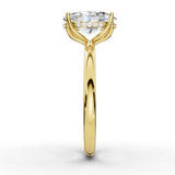 A yellow gold solitaire engagement ring featuring a large oval-cut clear gemstone accented by a row of small round diamonds along the band, set against a clean white background.