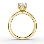 A yellow gold solitaire engagement ring with a large round-cut diamond center stone and smaller accent diamonds on the shoulders, shown on a clean white background.