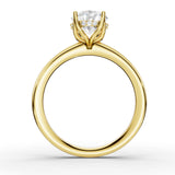 A yellow gold solitaire engagement ring with a large round-cut diamond center stone and smaller accent diamonds on the shoulders, shown on a clean white background.