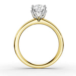 A yellow gold ring with a white gold or platinum four-prong setting holding a round brilliant-cut diamond, shown on a clean white background.