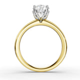 A yellow gold ring with a white gold or platinum four-prong setting holding a round brilliant-cut diamond, shown on a clean white background.