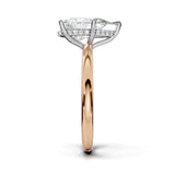 A rose gold engagement ring featuring a large pear-cut center diamond surrounded by a halo of small clear stones, set on a polished rose gold band against a white background.