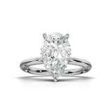 A pear-cut diamond solitaire engagement ring in a polished four-prong white gold or platinum setting, centered on a clean white background with a soft shadow.
