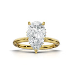 A pear-cut diamond engagement ring in a yellow gold setting, centered on a clean white background.
