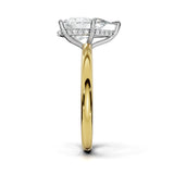 A diamond engagement ring with a marquise-cut center stone and a halo of small diamonds, set in a silver-colored metal with a yellow gold band, shown on a white background.