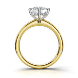 A yellow gold ring with a silver-colored solitaire setting holding a clear gemstone, shown on a white background.